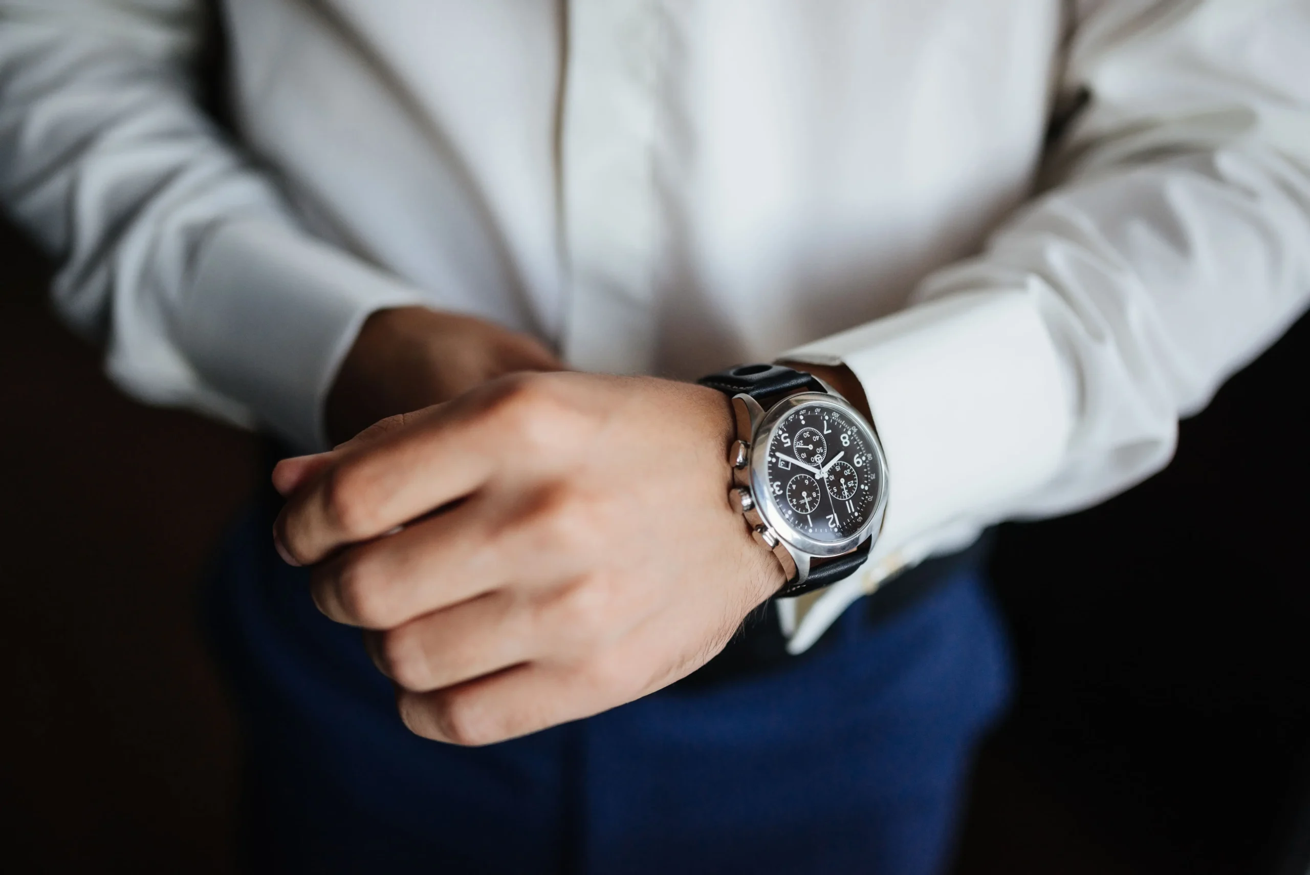 Man wearing a stylish mechanical watch with formal suit showcasing luxury timepiece design