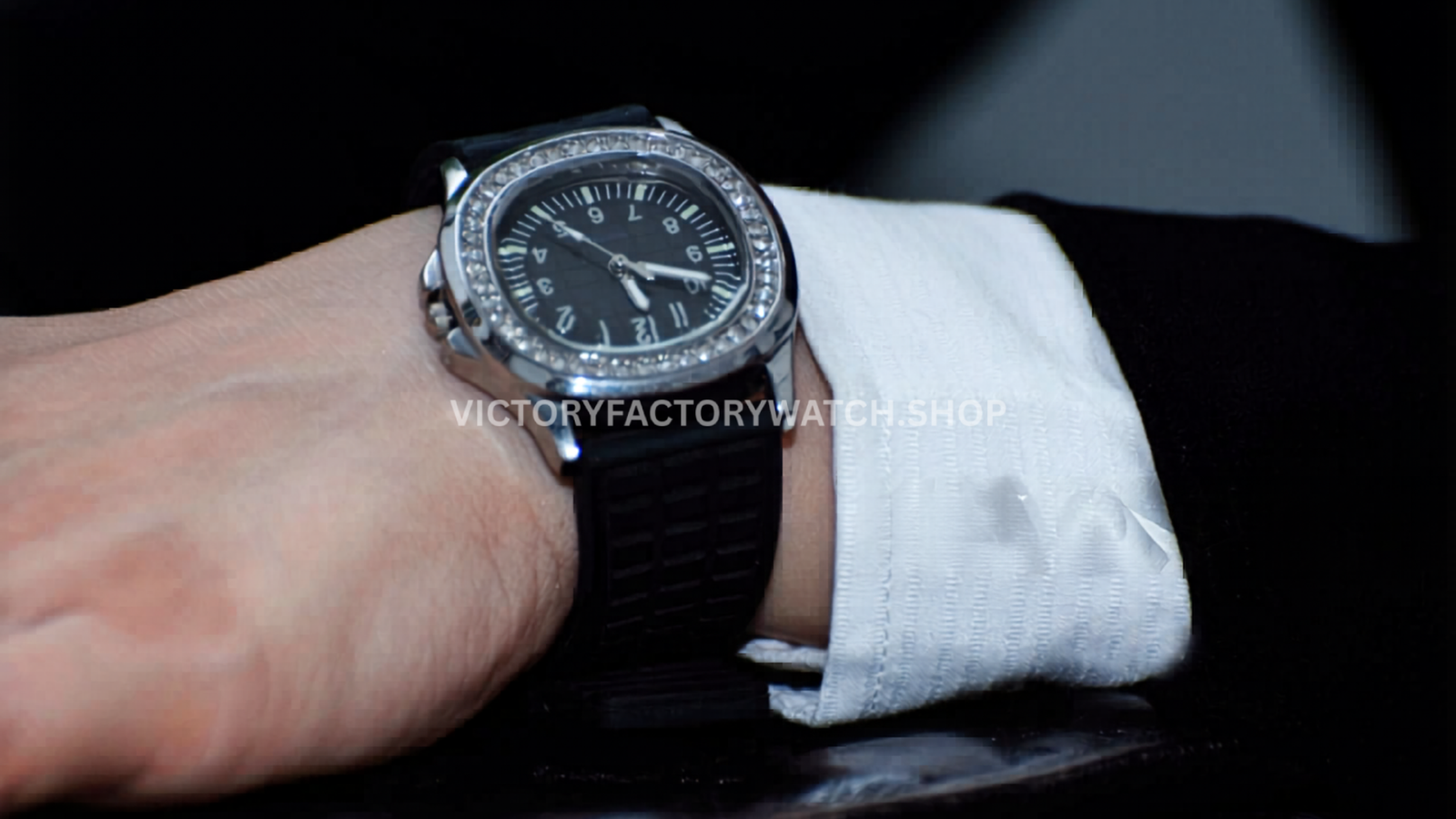Close-up wrist shot of a Nautilus-style watch with a diamond bezel and black strap, demonstrating how the watch fits for everyday wear and highlighting its elegant proportions.