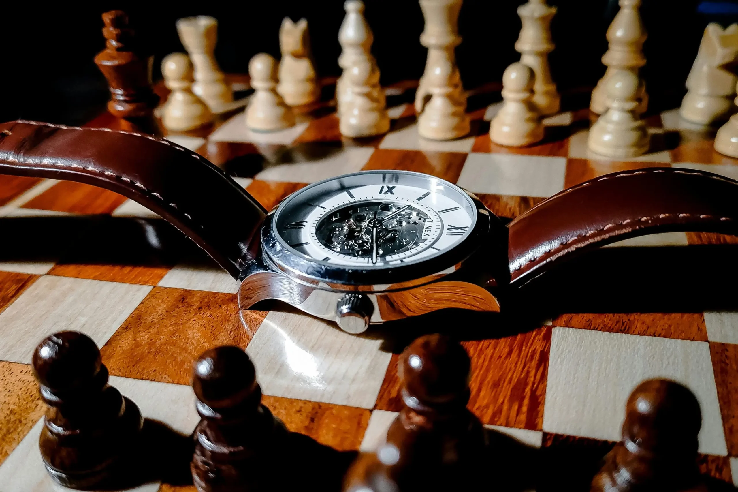 A classic skeleton watch placed on a chessboard symbolizing precision and strategy, commonly used in high-end replica watch storytelling when showcasing VSF and victory factory collections.